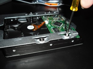 DSCF0018 Use the screws attached to the carrier to attach it to the hard drive. This is the only part of the process that requires a tool — a small Phillips screwdriver.