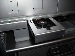 DSCF0019 Lift the latch on the rear of the computer and slide the hard drive carrier back into the computer.